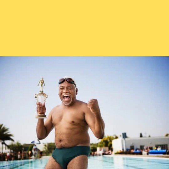 a man in a swimsuit holding a trophy