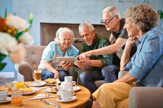 idosos ao redor de mesa de confraternização