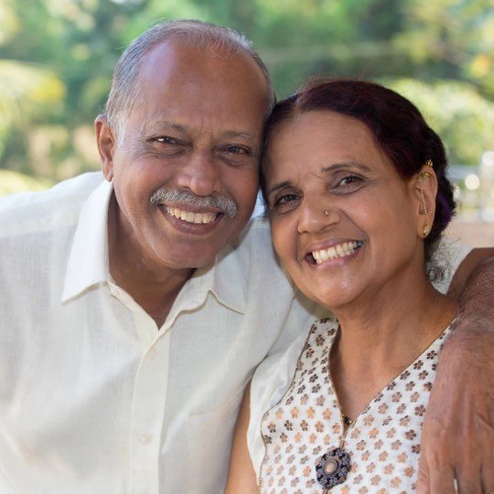 Casal de idosos abraçados e sorridentes